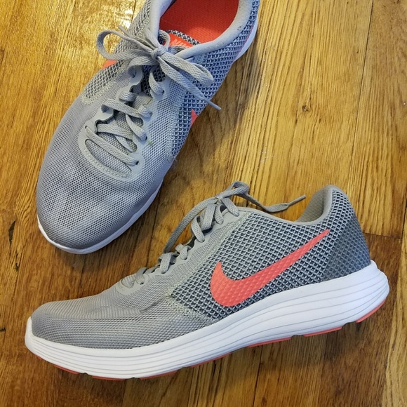 grey nike shoes with orange swoosh